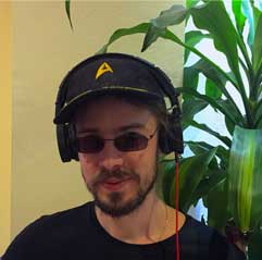 A man in a baseball cap with headphones